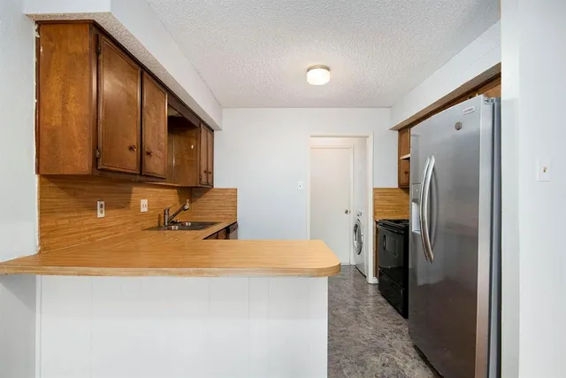a kitchen with a refrigerator and cabinets