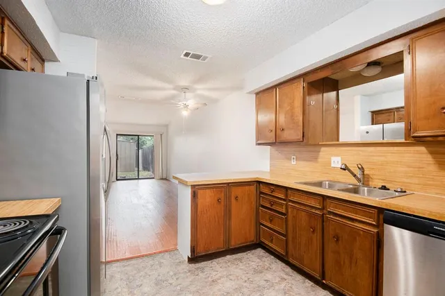 a kitchen with a sink and cabinets