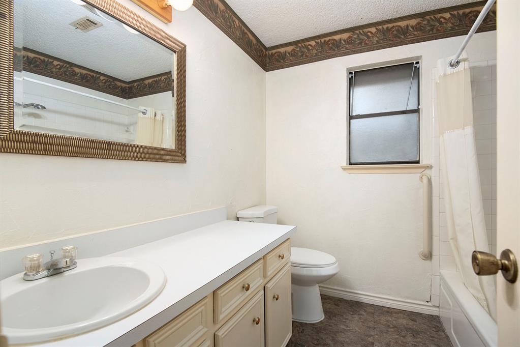 6817 West Cleburne Road Fort Worth, TX 76133 - Photo 22 of 24 a bathroom with a sink a toilet and shower