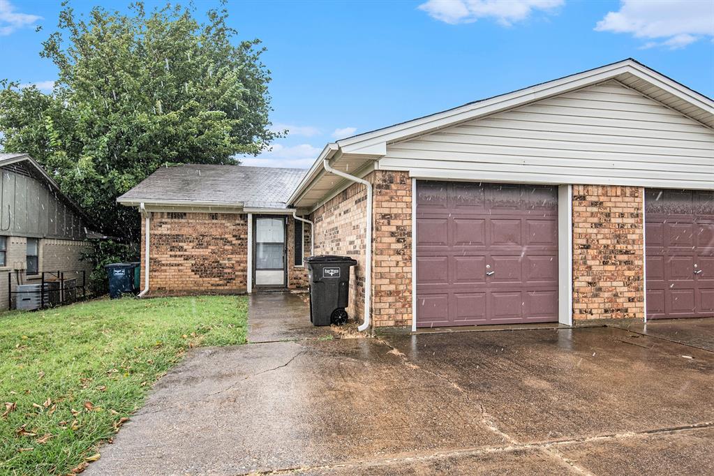 6817 West Cleburne Road Fort Worth, TX 76133 - Photo 3 of 24 a front view of a house with a yard and garage