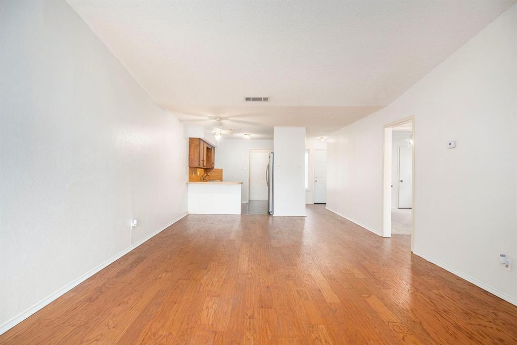 6817 West Cleburne Road Fort Worth, TX 76133 - Photo 9 of 24 a view of an empty room with wooden floor