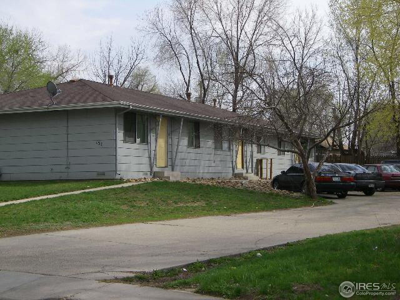 131 Reed Place, Unit 3 Longmont, CO 80504 - Photo 1 of 3 a front view of a house with a garden and yard