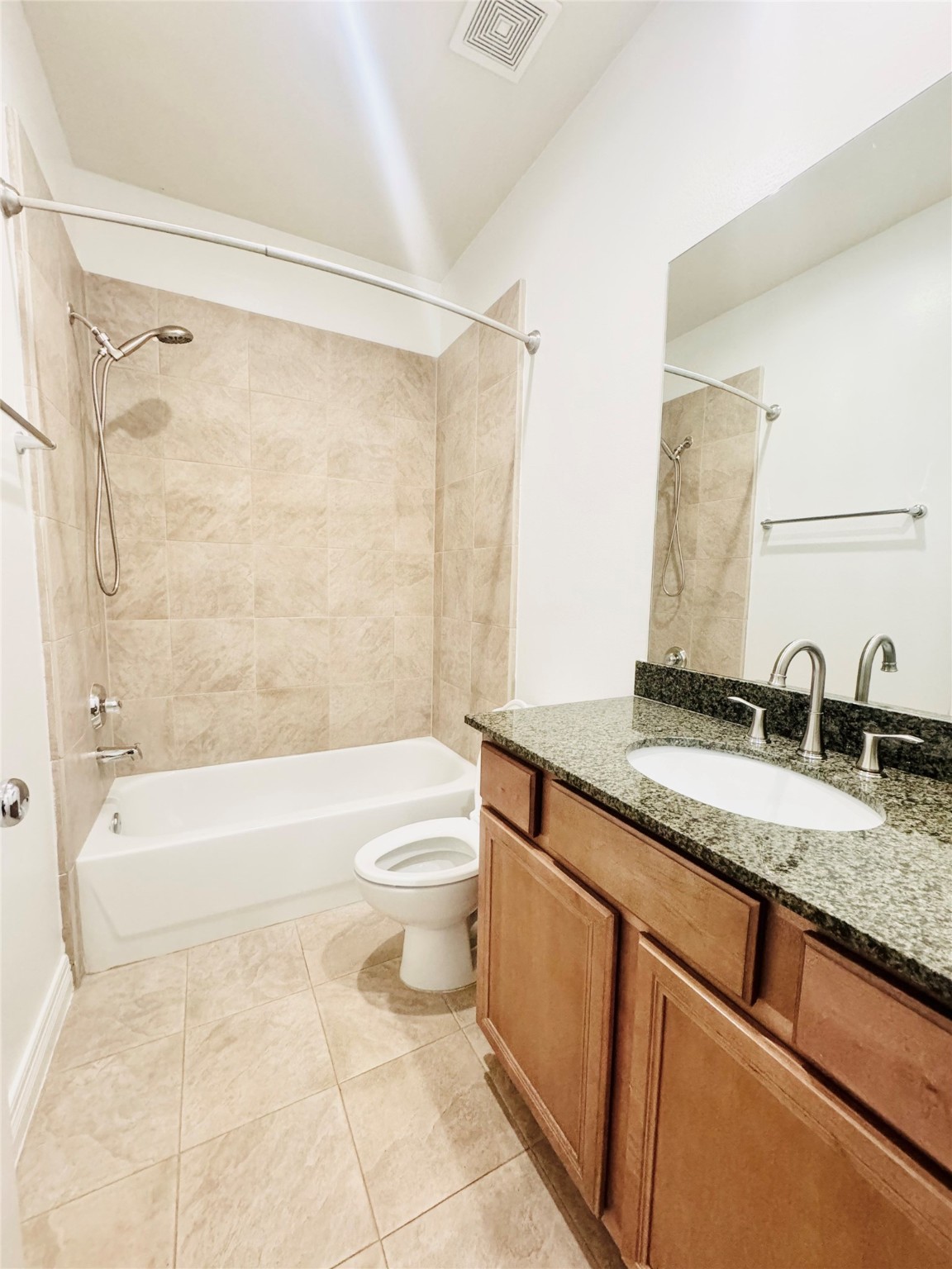 3846 Center Street Houston, TX 77007 - Photo 12 of 37 a bathroom with a granite countertop sink a toilet and a bathtub