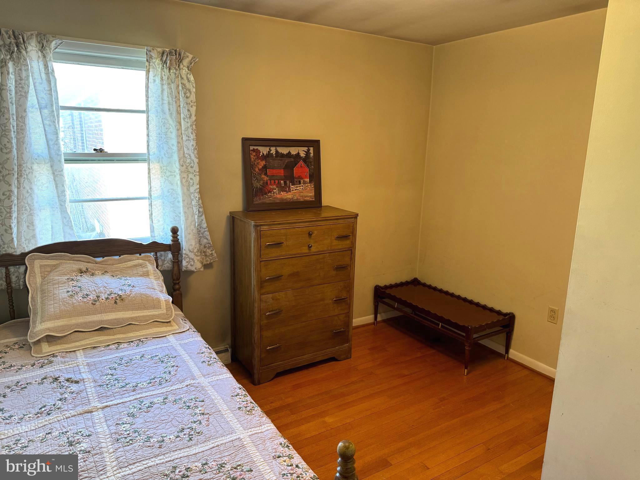 1309 Commerce Street Winchester, VA 22601 - Photo 16 of 27 a bedroom with a bed and wooden floor