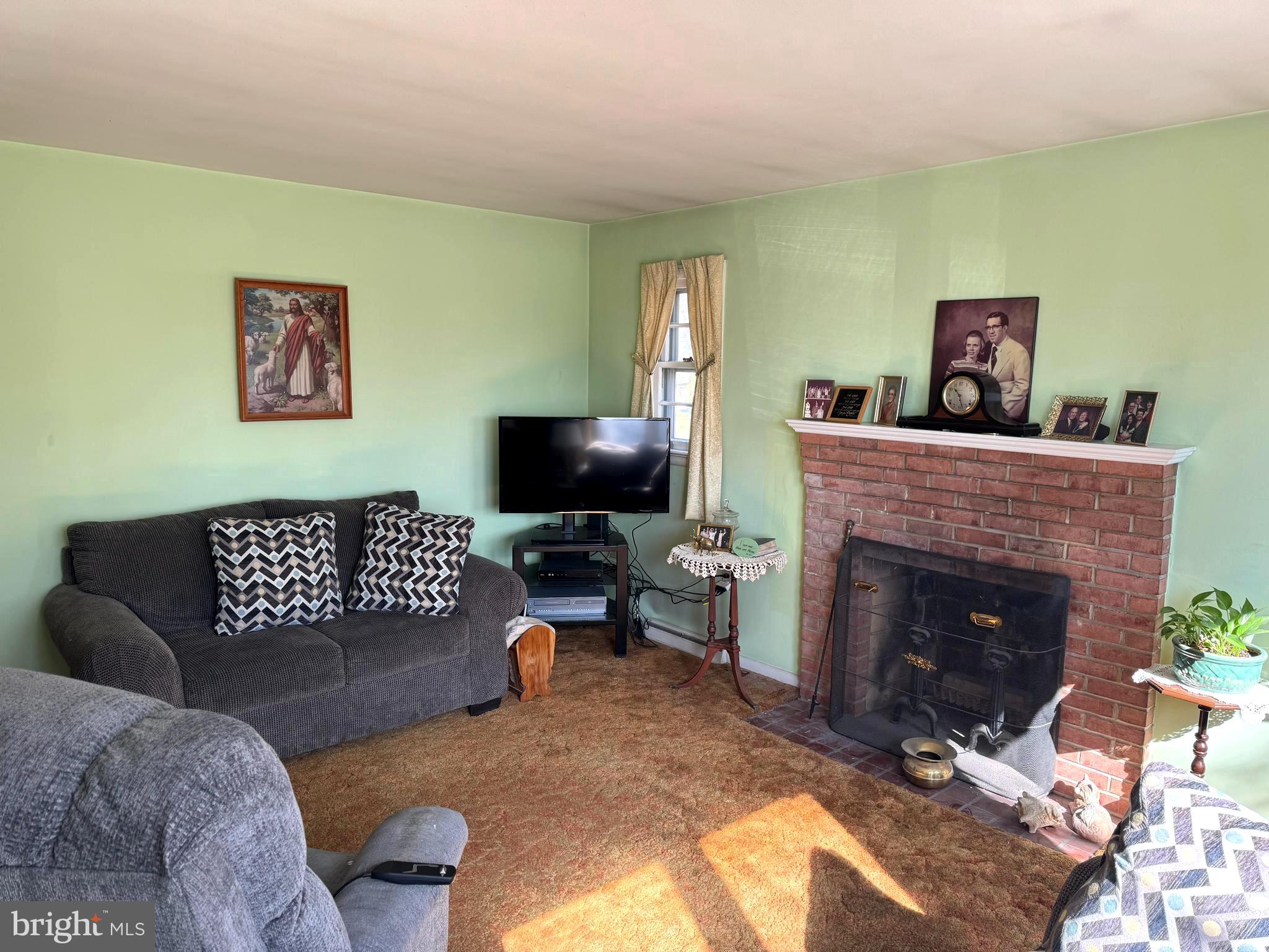 1309 Commerce Street Winchester, VA 22601 - Photo 5 of 27 a living room with furniture and a fireplace