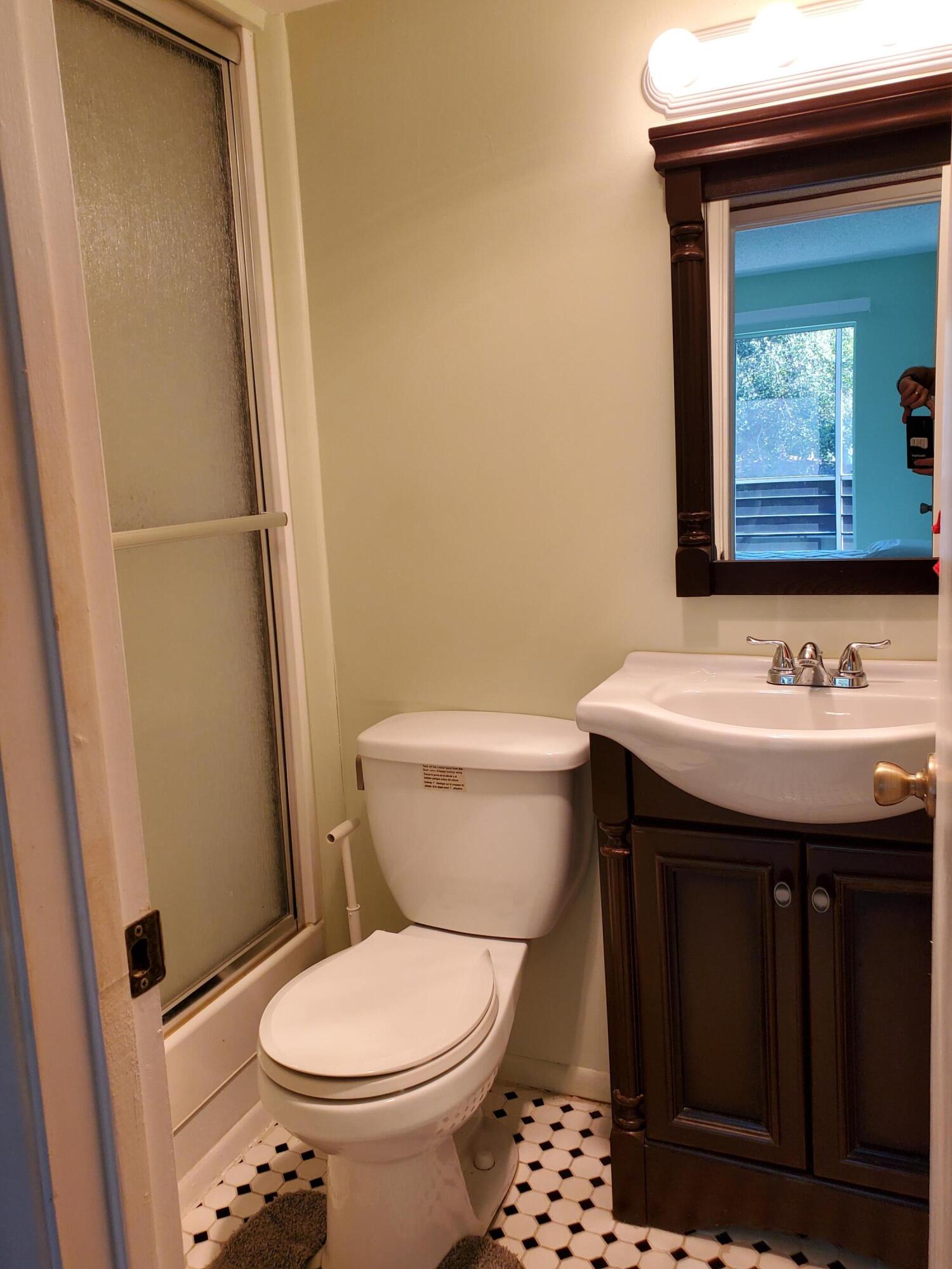 3300 Springdale Boulevard, Unit 318 Palm Springs, FL 33461 - Photo 21 of 34 a bathroom with a sink and a toilet