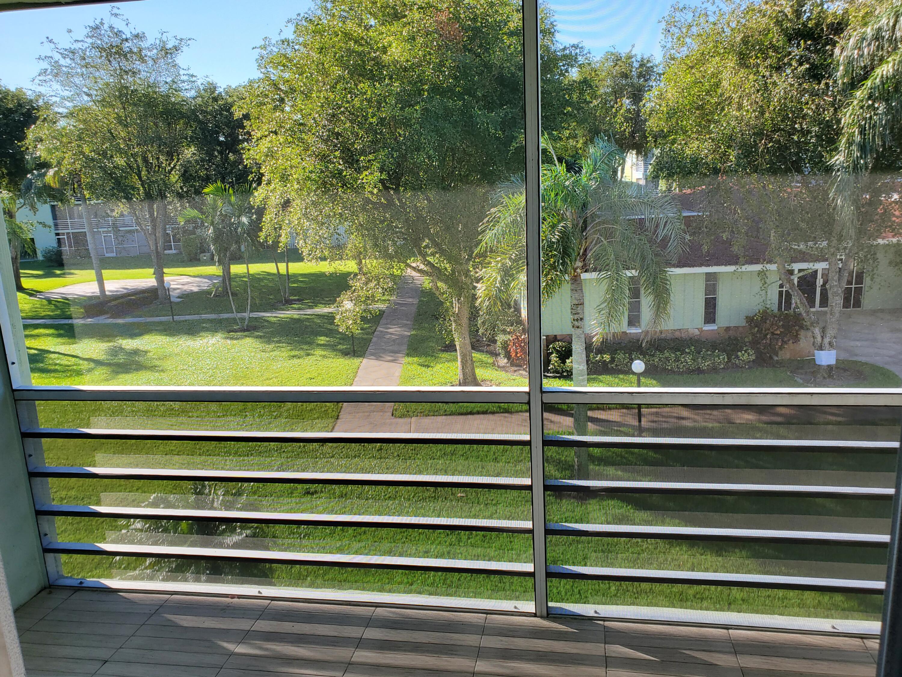 3300 Springdale Boulevard, Unit 318 Palm Springs, FL 33461 - Photo 23 of 34 a view of backyard with swimming pool and outdoor seating