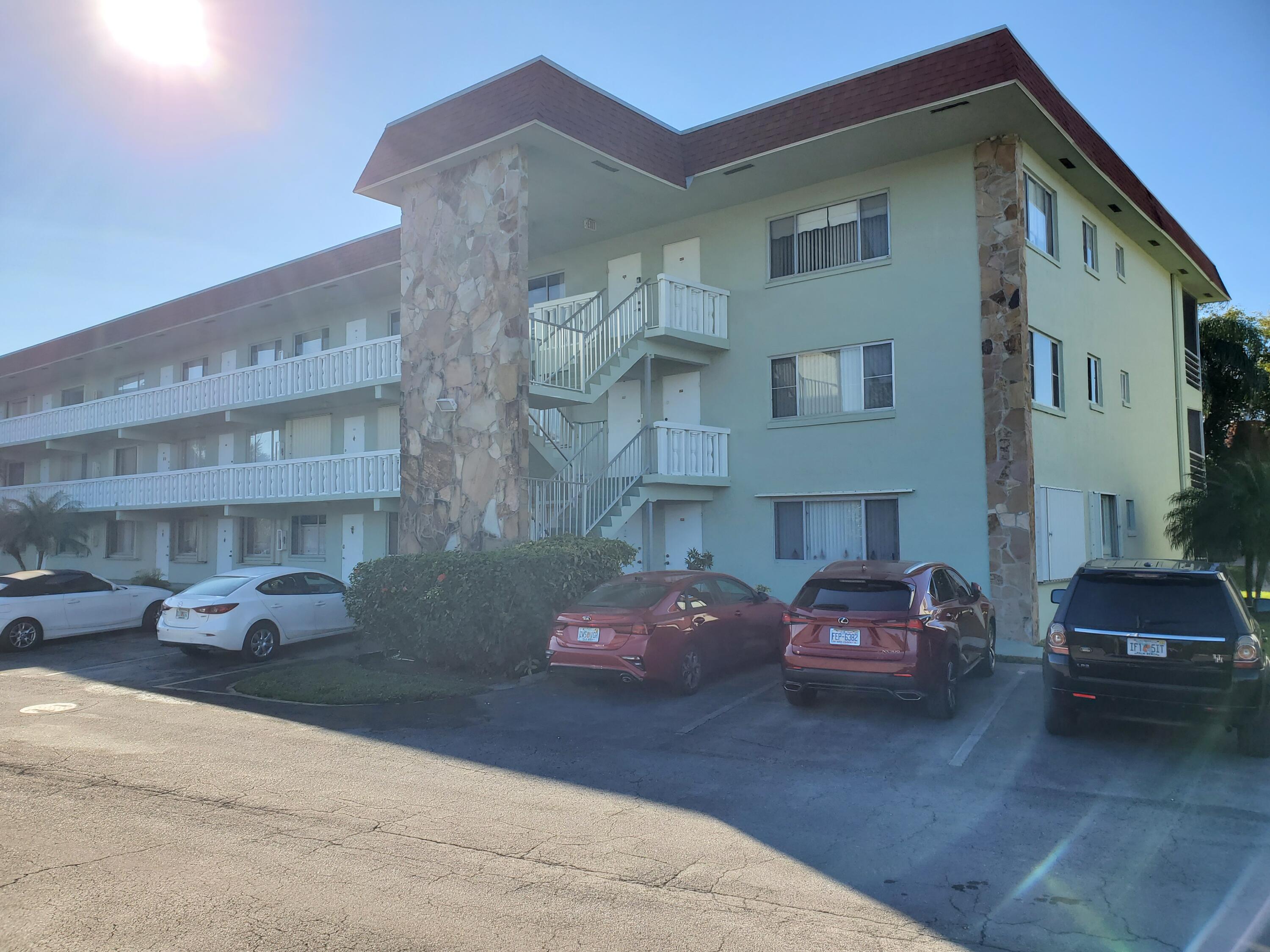 3300 Springdale Boulevard, Unit 318 Palm Springs, FL 33461 - Photo 3 of 34 a car parked in front of a building
