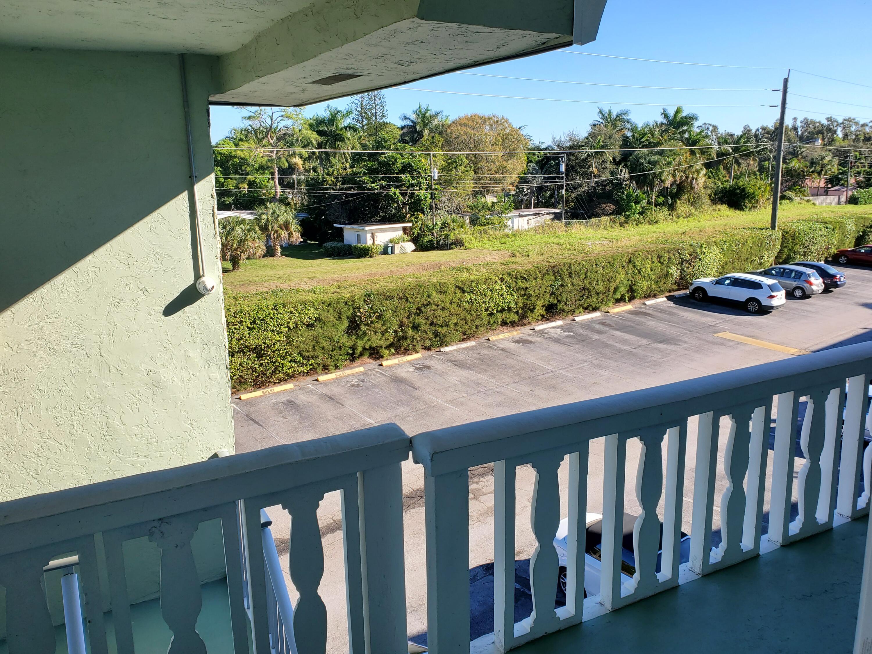 3300 Springdale Boulevard, Unit 318 Palm Springs, FL 33461 - Photo 5 of 34 a balcony view with a garden