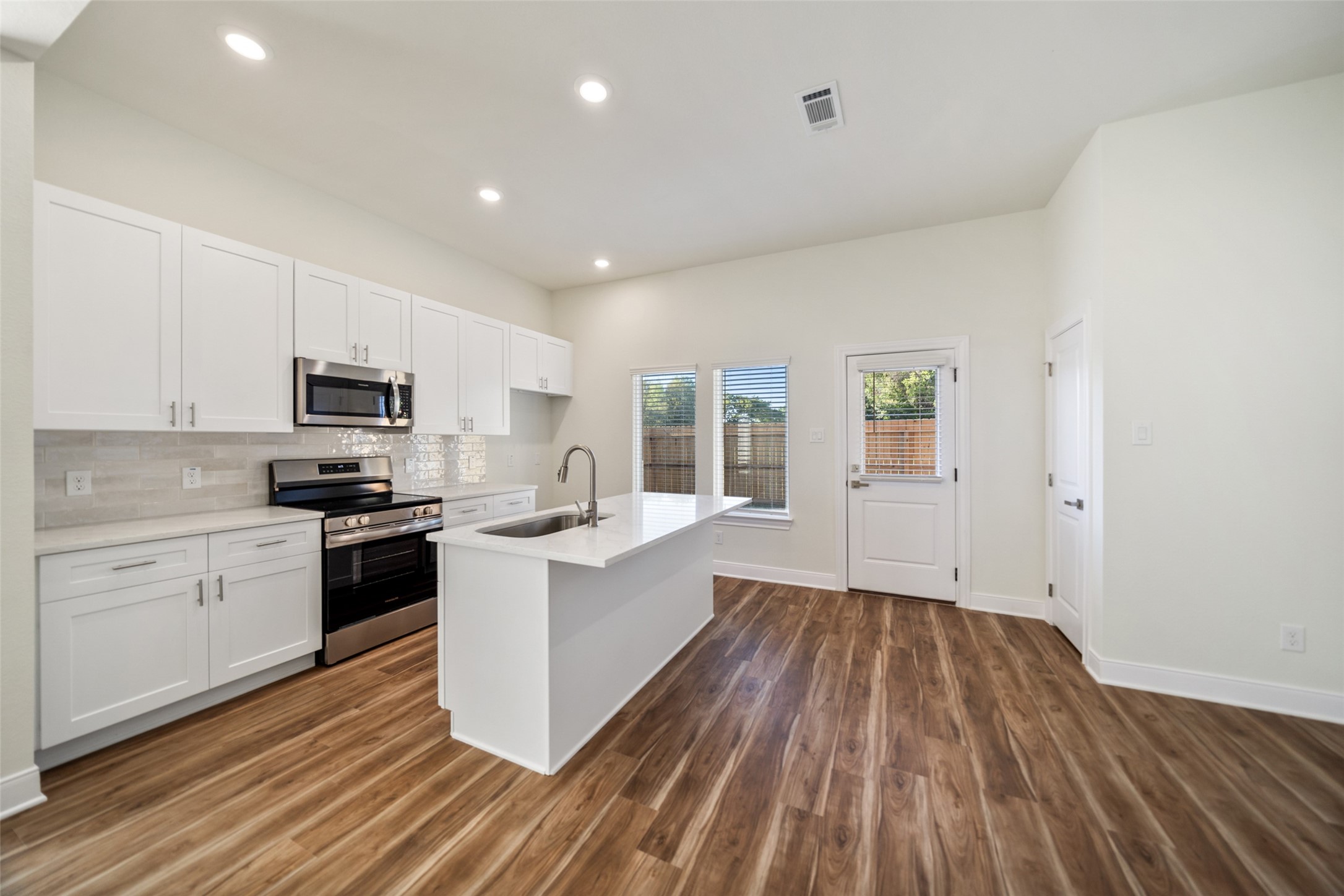 412 West Marlin Street Willis, TX 77378 - Photo 6 of 22 a kitchen with a sink window and stainless steel appliances