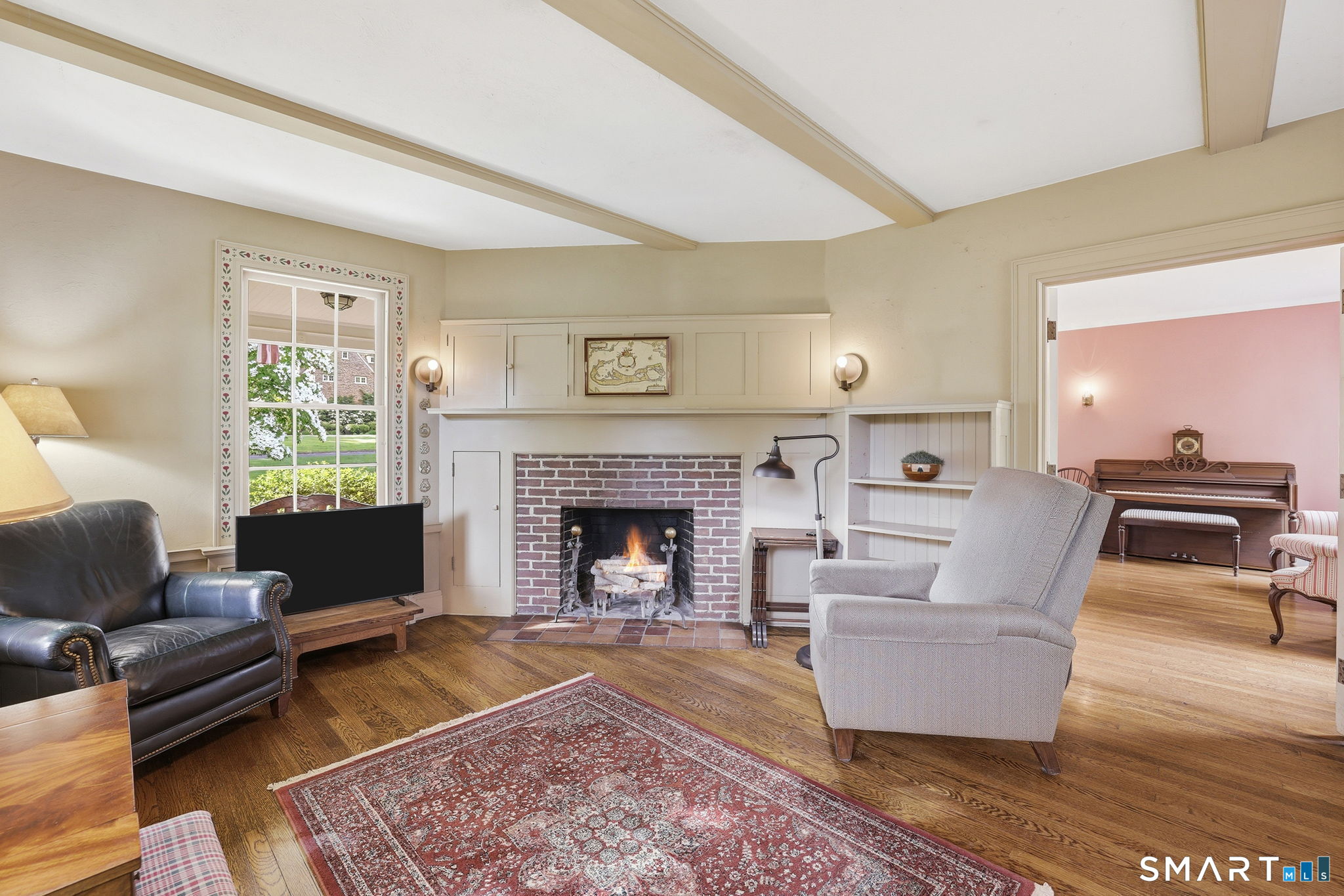 73 Inwood Road Fairfield, CT 06825 - Photo 19 of 40 We love this charming, cozy den with working fireplace and access to the 3 season porch.