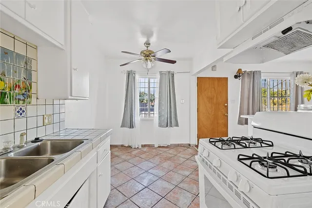 a kitchen with sink a stove and refrigerator