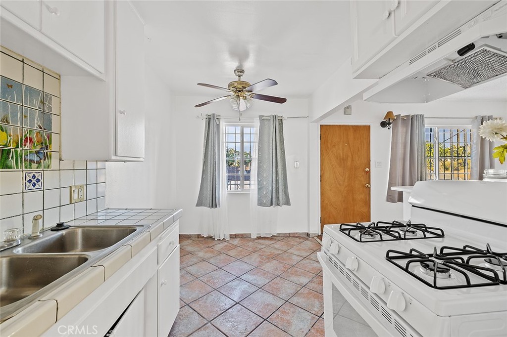 330 West Laurel Street, Unit C Compton, CA 90220 - Photo 12 of 16 a kitchen with sink a stove and refrigerator