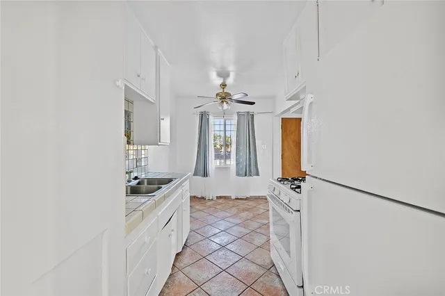 a bathroom with a granite countertop sink a vanity and window