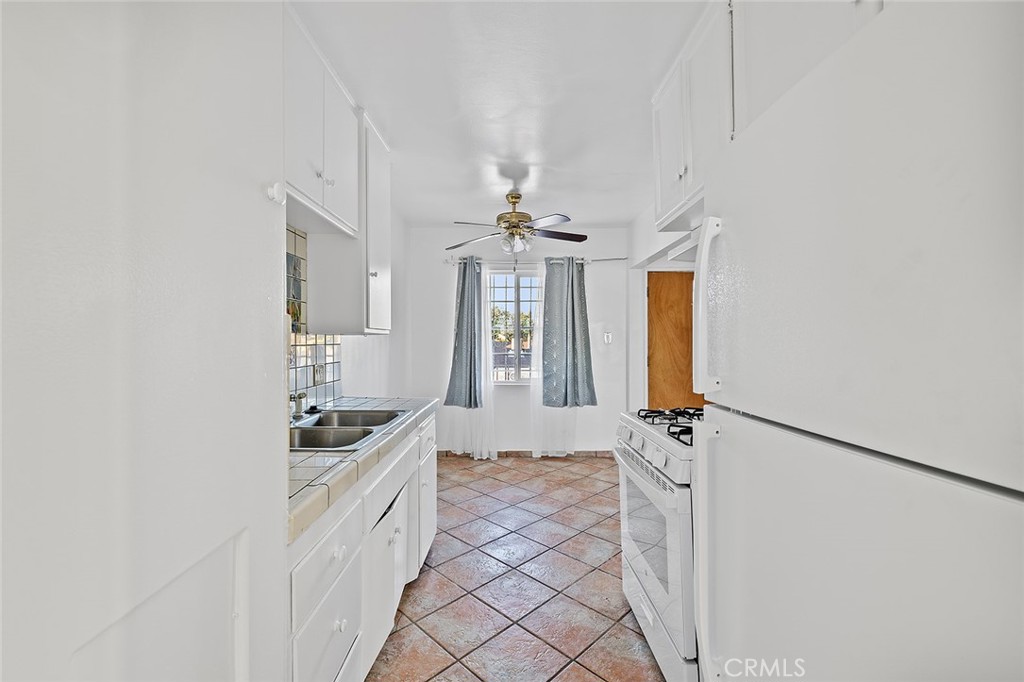 330 West Laurel Street, Unit C Compton, CA 90220 - Photo 13 of 16 a bathroom with a granite countertop sink a vanity and window