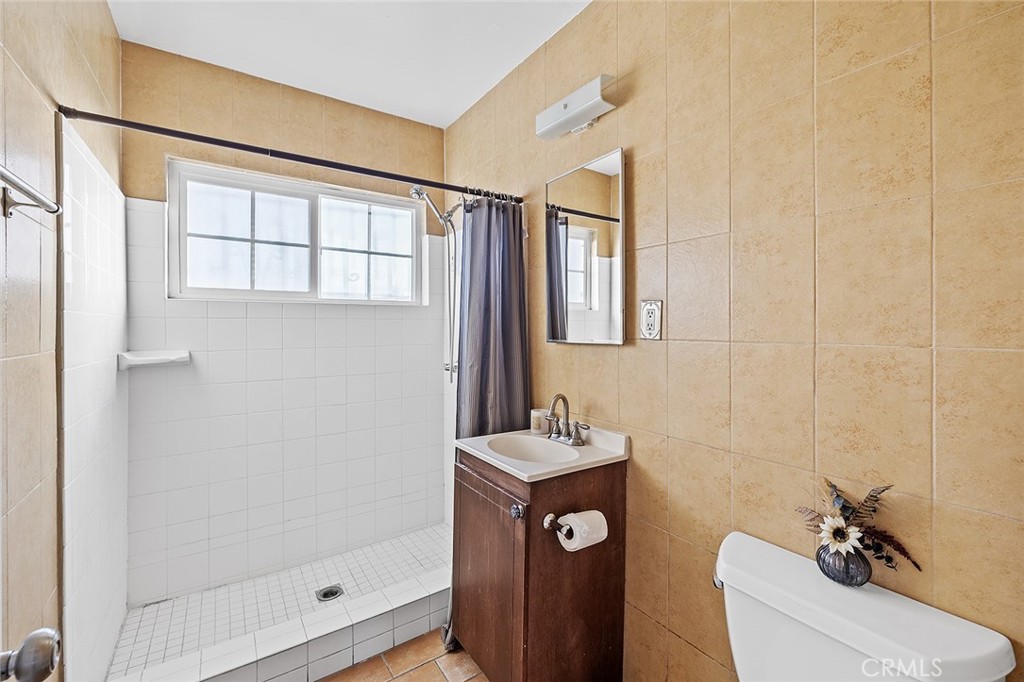 330 West Laurel Street, Unit C Compton, CA 90220 - Photo 14 of 16 a bathroom with a sink a toilet and shower