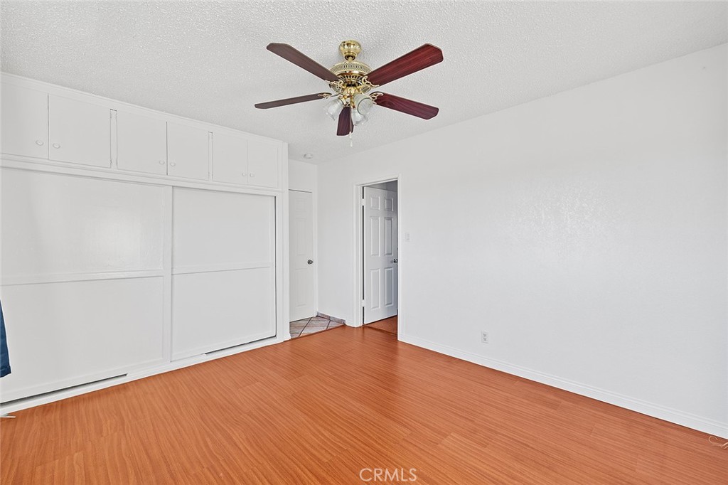330 West Laurel Street, Unit C Compton, CA 90220 - Photo 16 of 16 an empty room with wooden floor and a ceiling fan