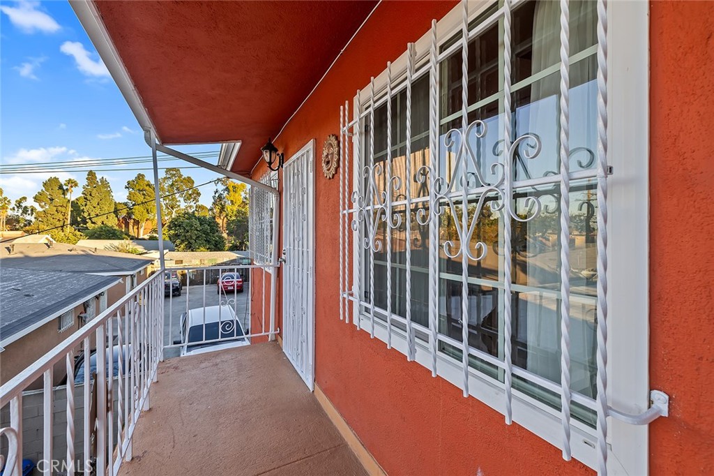 330 West Laurel Street, Unit C Compton, CA 90220 - Photo 3 of 16 a view of balcony with wooden floor and fence