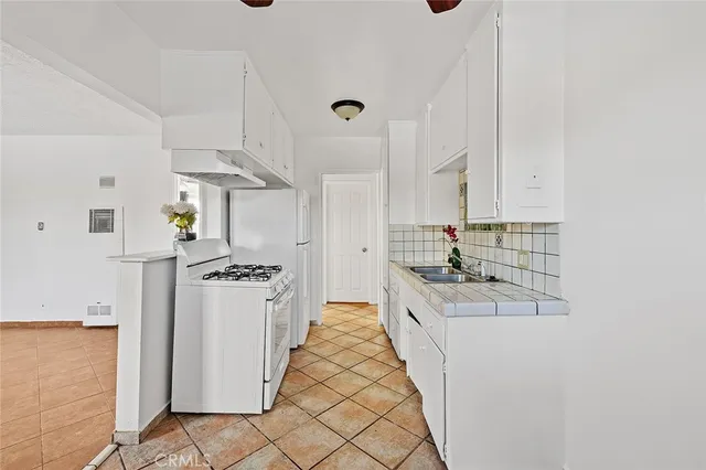 a kitchen with stainless steel appliances granite countertop a stove and a refrigerator