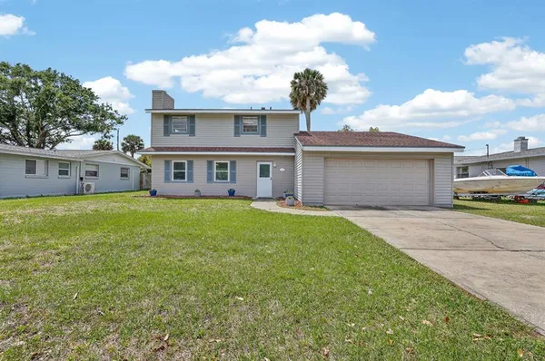 a view of a house with a yard and garage