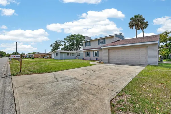 a front view of a house with a garden and yard