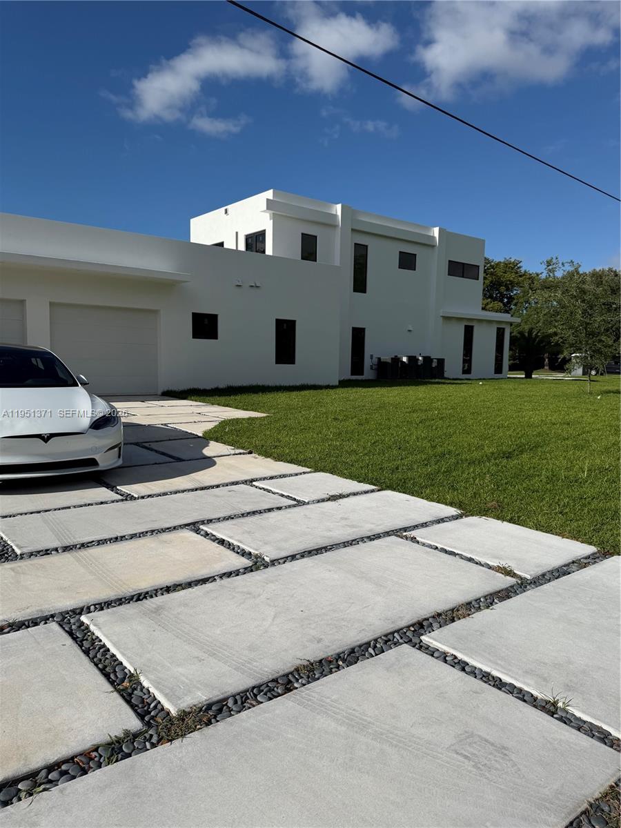6190 Southwest 128th Street Pinecrest, FL 33156 - Photo 1 of 34 a aerial view of a house with a yard and garage
