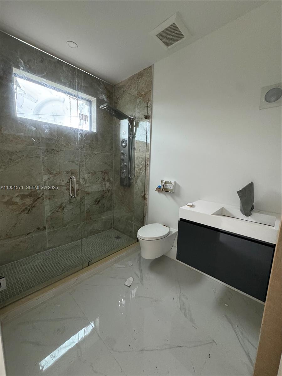 6190 Southwest 128th Street Pinecrest, FL 33156 - Photo 13 of 34 a bathroom with a sink a toilet and shower