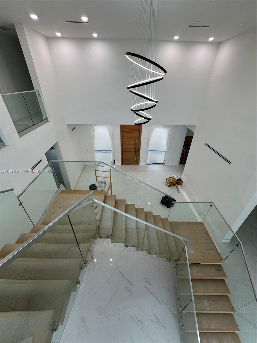 6190 Southwest 128th Street Pinecrest, FL 33156 - Photo 16 of 34 a room with gym equipment and a view of living room