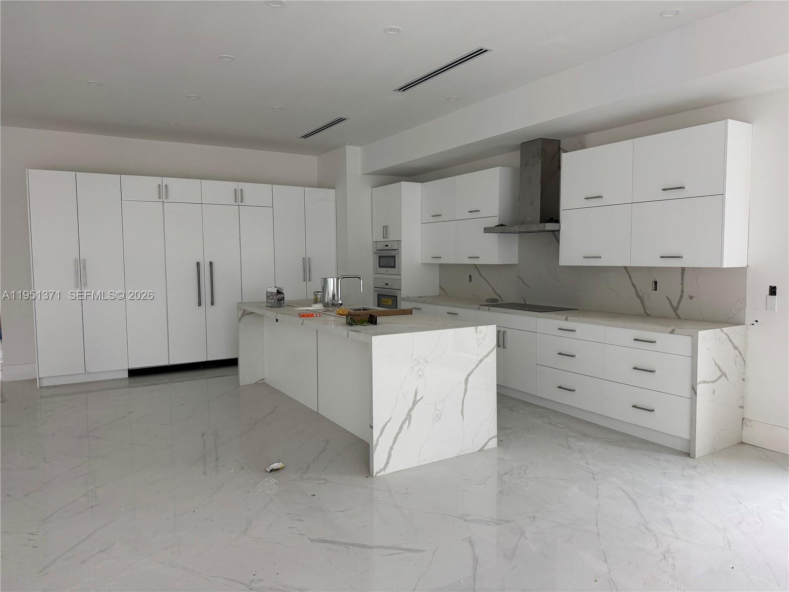 6190 Southwest 128th Street Pinecrest, FL 33156 - Photo 18 of 34 a kitchen with white cabinets and white appliances