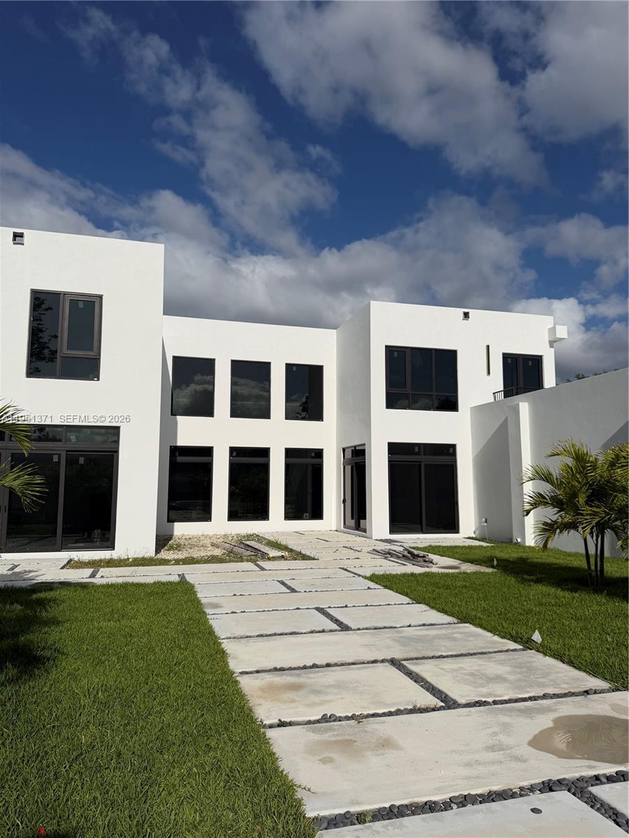 6190 Southwest 128th Street Pinecrest, FL 33156 - Photo 2 of 34 a front view of a building with a garden