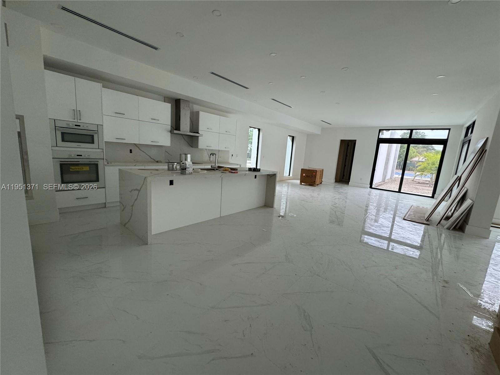 6190 Southwest 128th Street Pinecrest, FL 33156 - Photo 21 of 34 a kitchen with cabinets and wooden floor