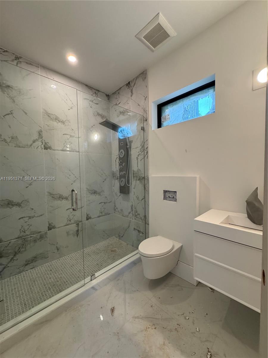 6190 Southwest 128th Street Pinecrest, FL 33156 - Photo 24 of 34 a bathroom with a granite countertop sink a toilet and shower