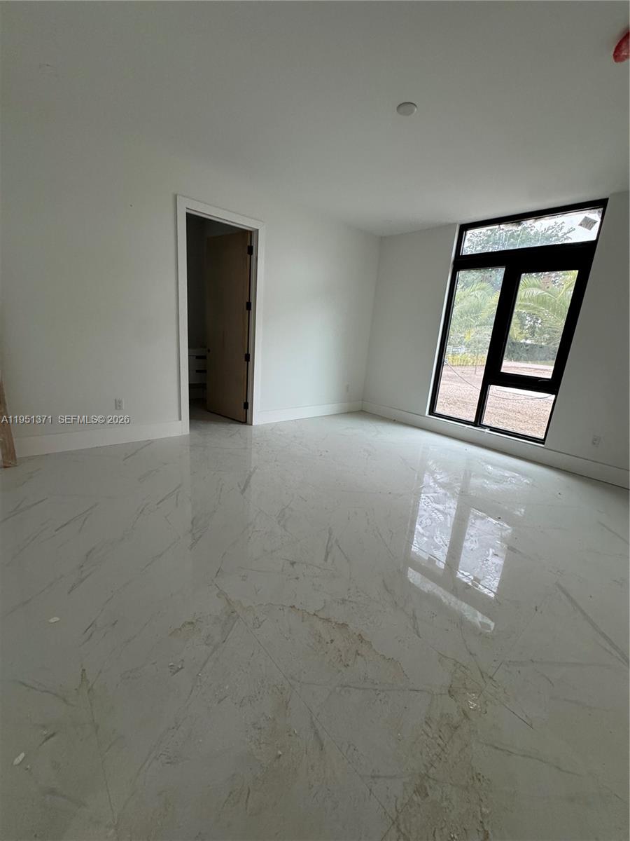 6190 Southwest 128th Street Pinecrest, FL 33156 - Photo 25 of 34 a view of an empty room with window and stairs