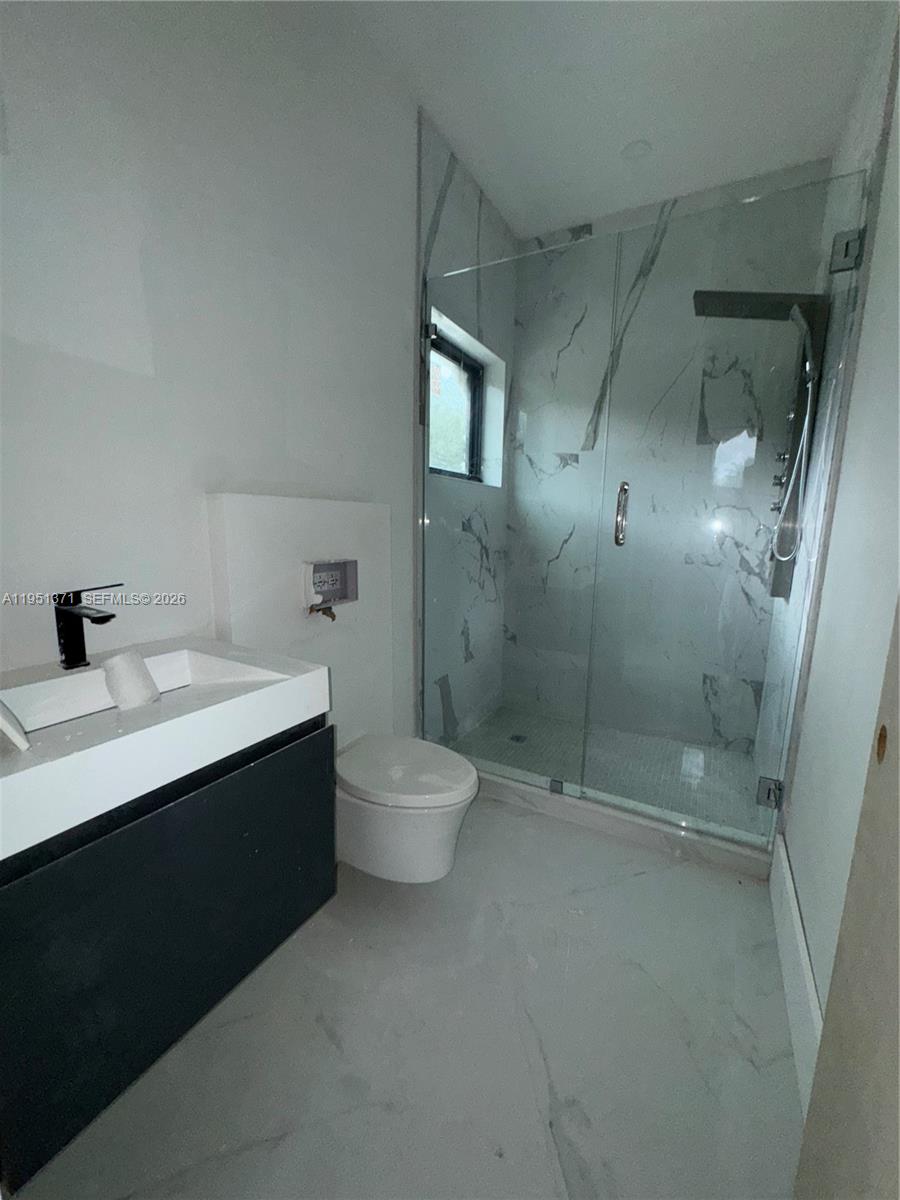 6190 Southwest 128th Street Pinecrest, FL 33156 - Photo 30 of 34 a bathroom with a sink toilet and shower