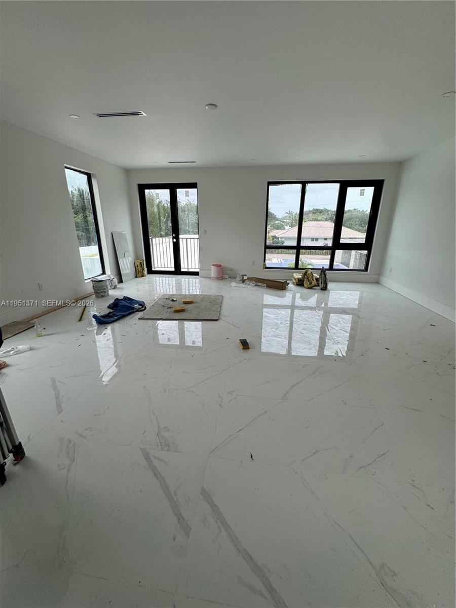 6190 Southwest 128th Street Pinecrest, FL 33156 - Photo 31 of 34 an empty room with windows and view of kitchen