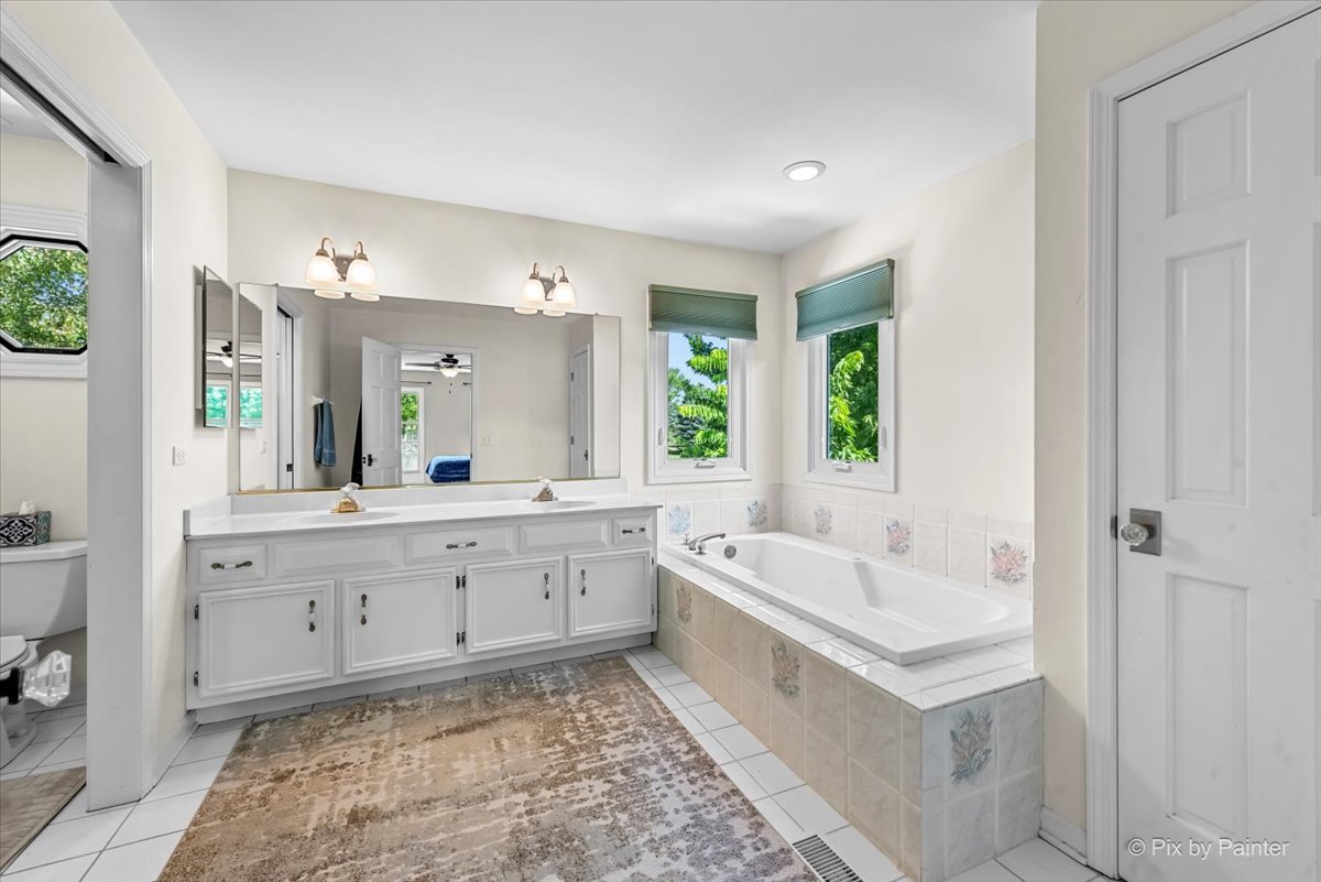 39W278 Baert Road St. Charles, IL 60175 - Photo 19 of 47 a spacious bathroom with a tub sink and mirror