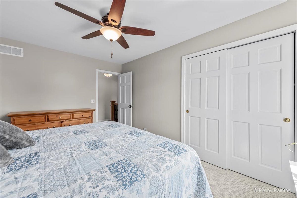 39W278 Baert Road St. Charles, IL 60175 - Photo 21 of 47 a bedroom with a large bed and a chandelier