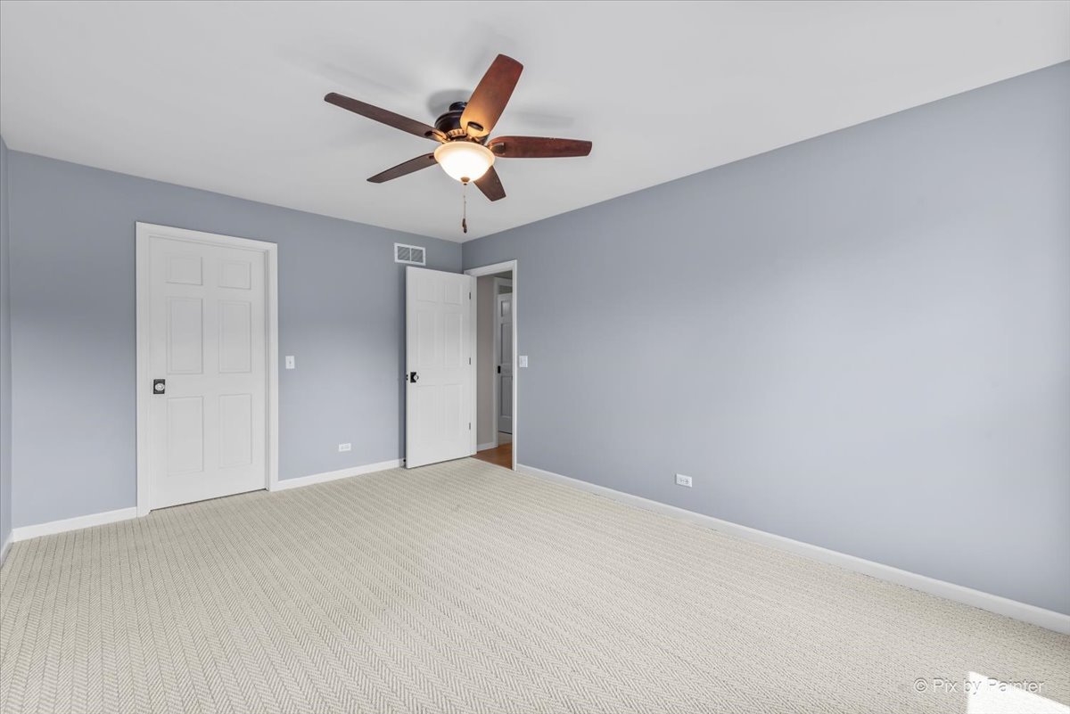 39W278 Baert Road St. Charles, IL 60175 - Photo 23 of 47 a view of a big room with a ceiling fan and wooden floor