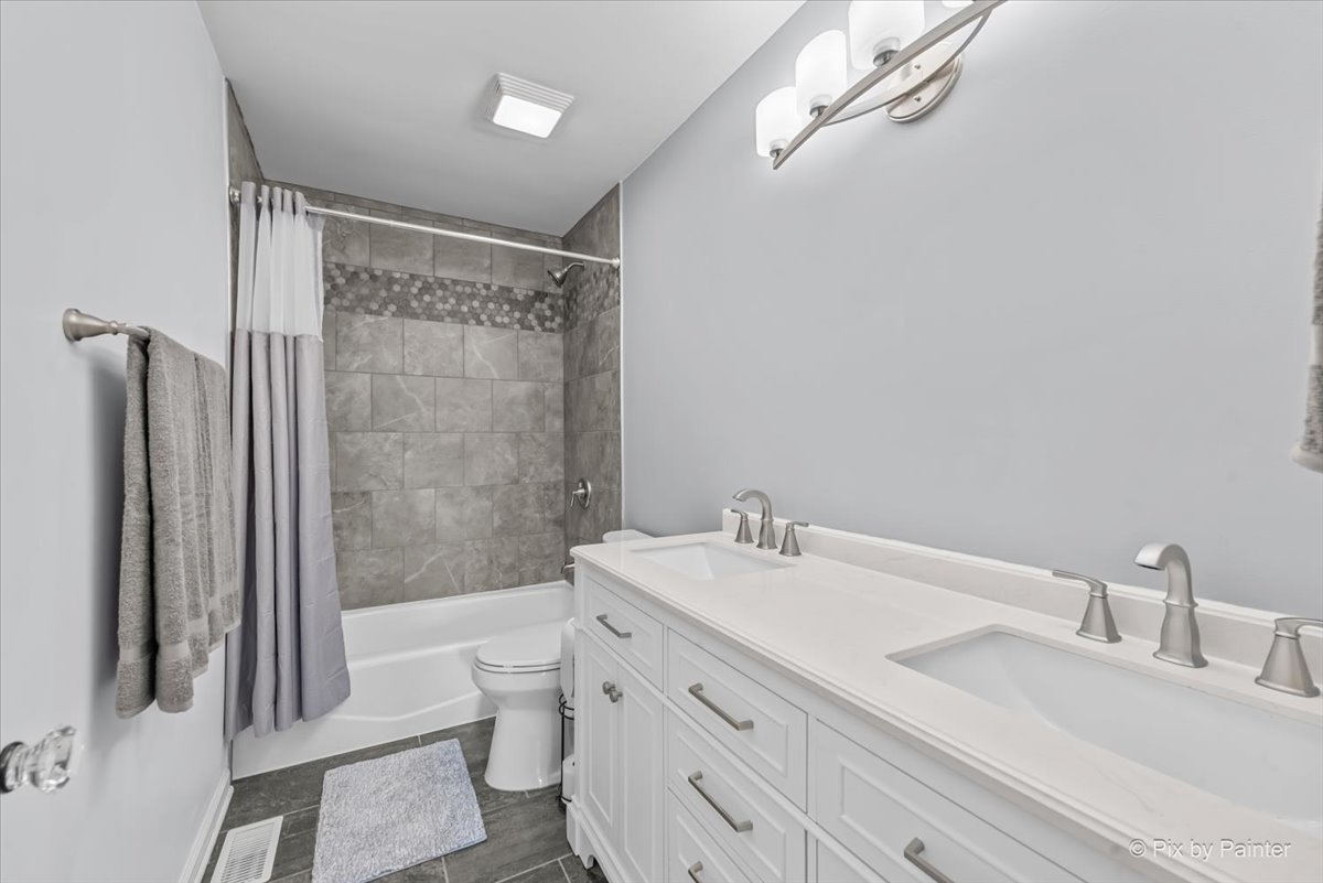 39W278 Baert Road St. Charles, IL 60175 - Photo 26 of 47 a bathroom with a double vanity sink toilet mirror and shower