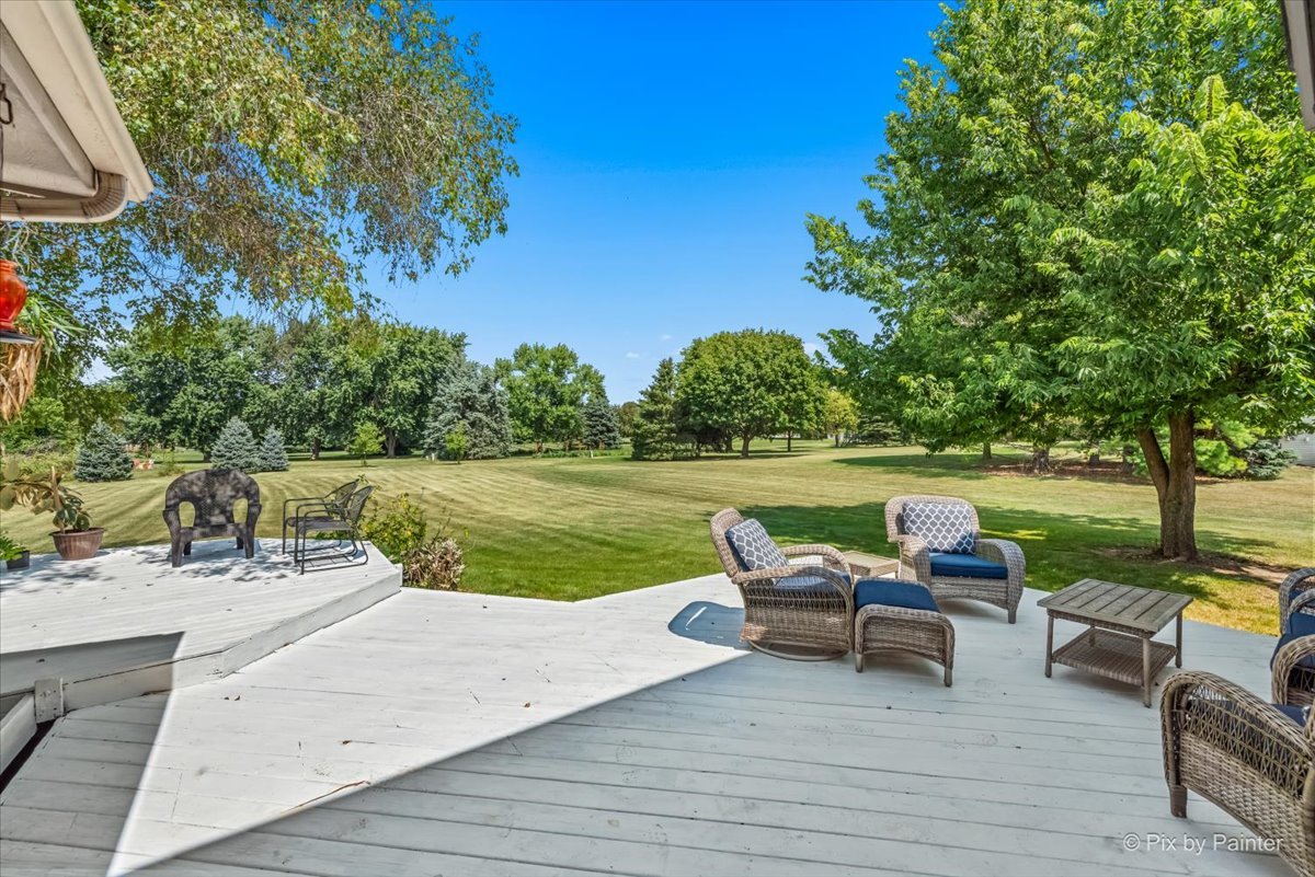 39W278 Baert Road St. Charles, IL 60175 - Photo 29 of 47 a view of a lake with couches and table and chairs under an umbrella