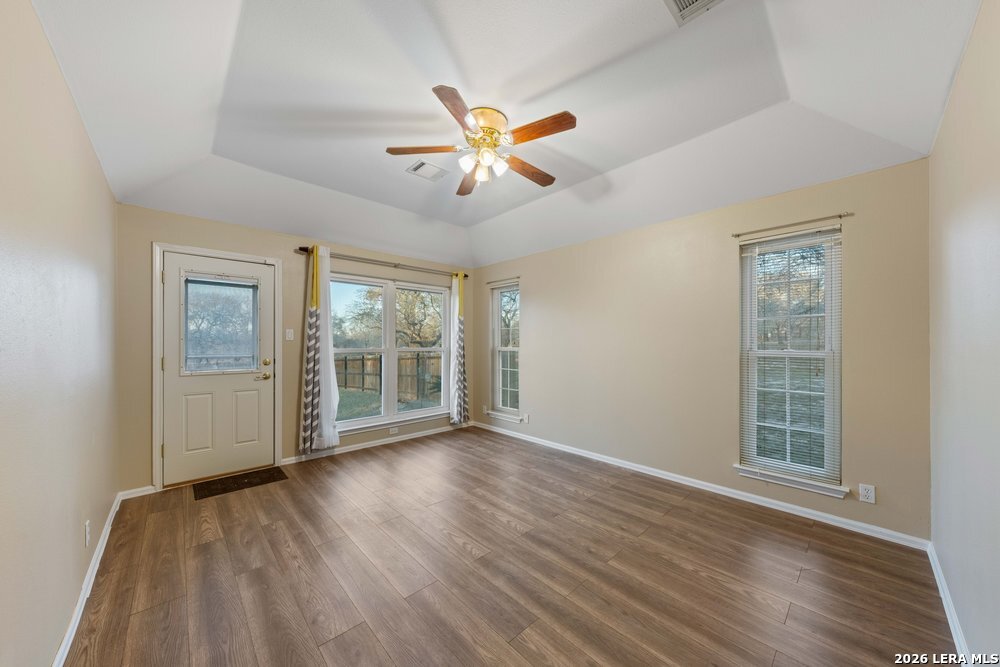 422 Arbor View Adkins, TX 78101 - Photo 13 of 29 a view of an empty room with a window and wooden floor