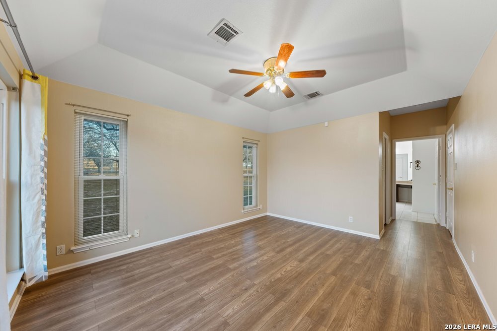 422 Arbor View Adkins, TX 78101 - Photo 14 of 29 wooden floor in an empty room with a window