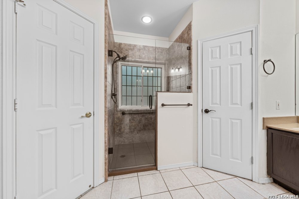 422 Arbor View Adkins, TX 78101 - Photo 15 of 29 a bathroom with a shower and closet