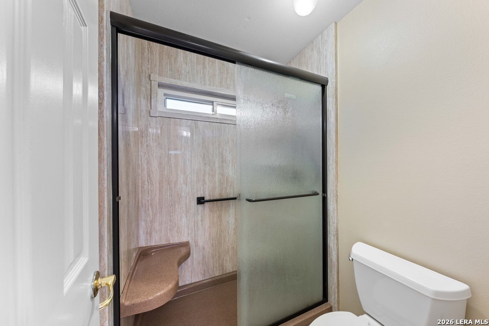 422 Arbor View Adkins, TX 78101 - Photo 22 of 29 a bathroom with a toilet and a shower