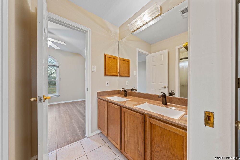 422 Arbor View Adkins, TX 78101 - Photo 23 of 29 a bathroom with a sink and a mirror