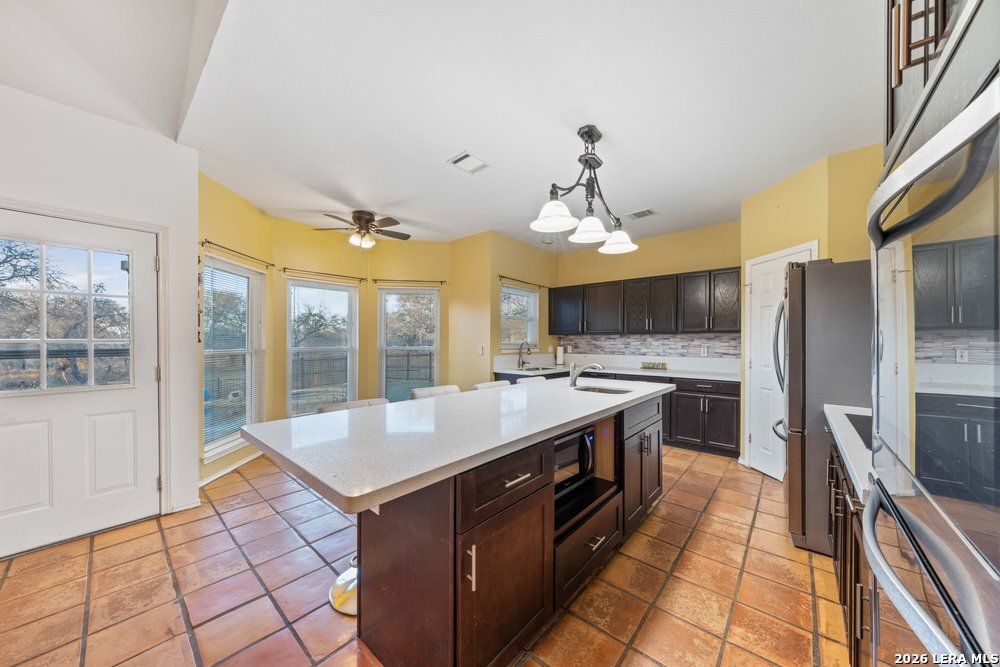422 Arbor View Adkins, TX 78101 - Photo 5 of 29 a large kitchen with kitchen island a large counter space a sink appliances and cabinets