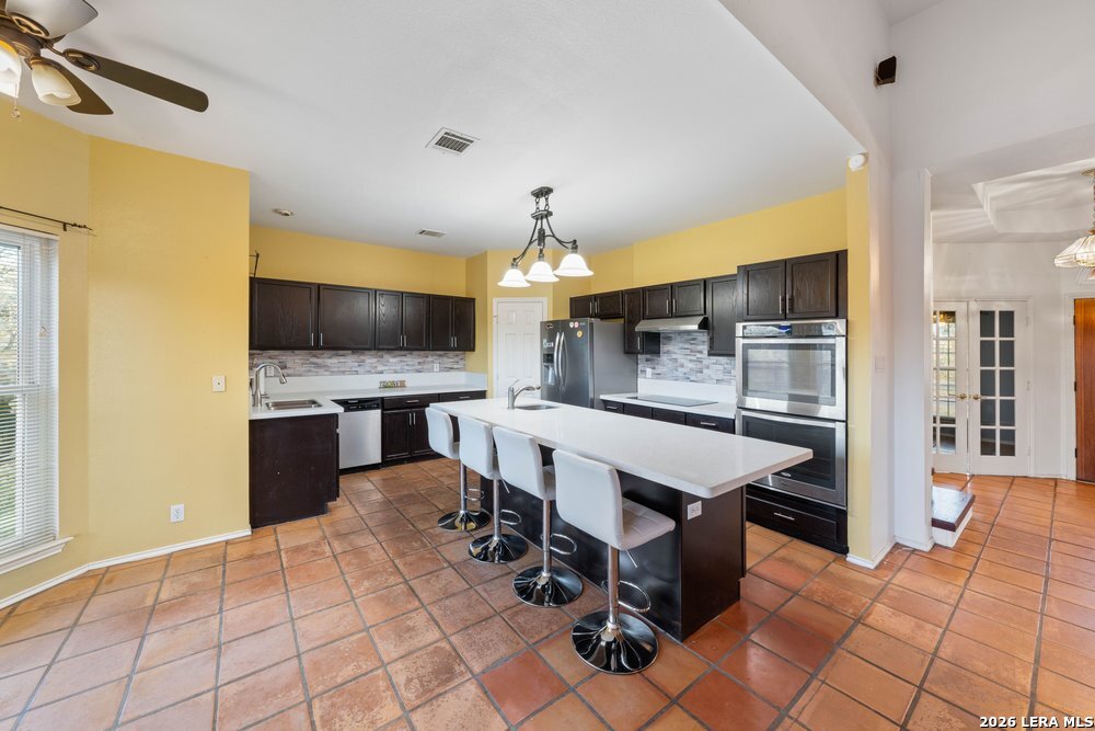 422 Arbor View Adkins, TX 78101 - Photo 6 of 29 a kitchen with a counter space a sink appliances and cabinets