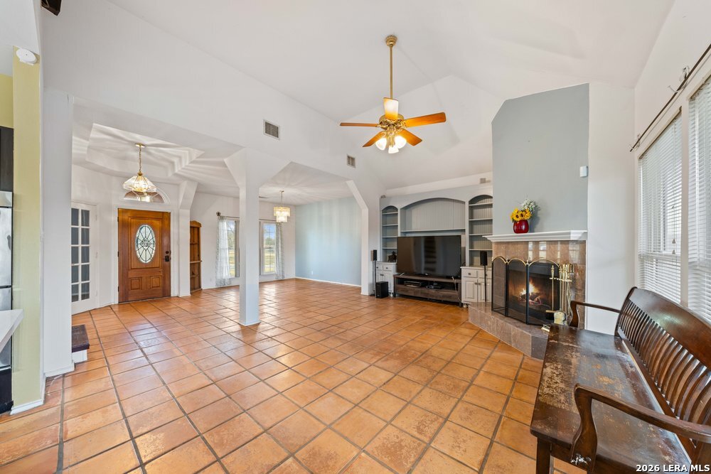 422 Arbor View Adkins, TX 78101 - Photo 9 of 29 a view of a livingroom with a fireplace and a chandelier