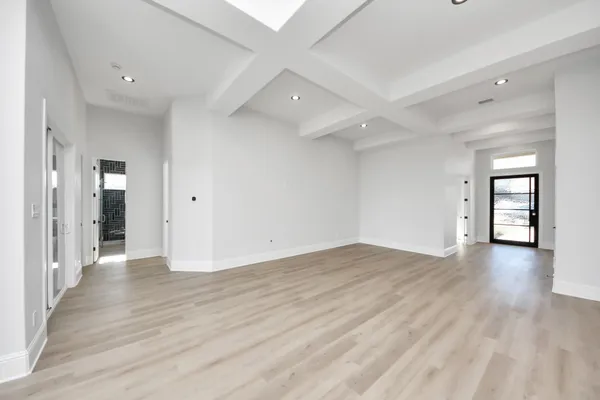 a large room with kitchen view and living room view