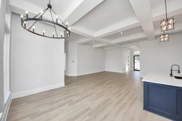 a kitchen with stainless steel appliances kitchen island granite countertop a sink cabinets and wooden floor